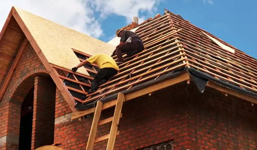 men repairing house roof