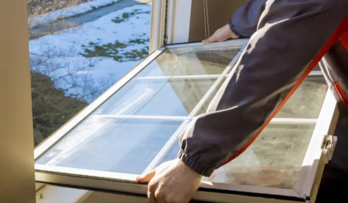 A professional installing energy-saving windows in a home, showcasing double-pane glass for insulation and energy efficiency.