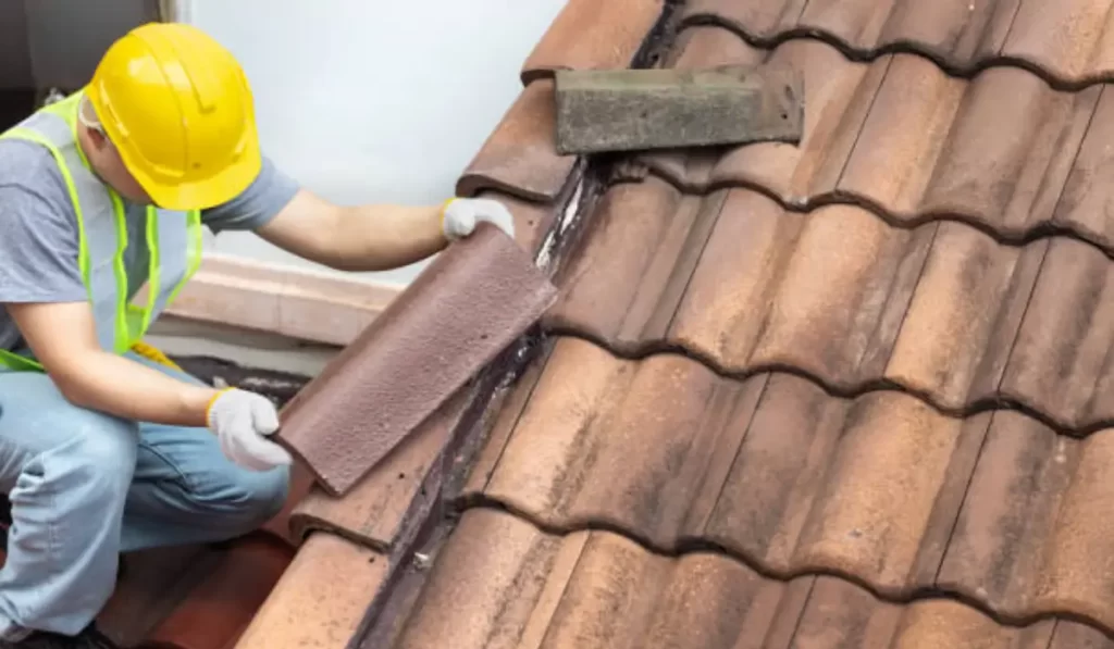 A roofing contractor providing professional roofing services by repairing a leaky roof with precision and care.