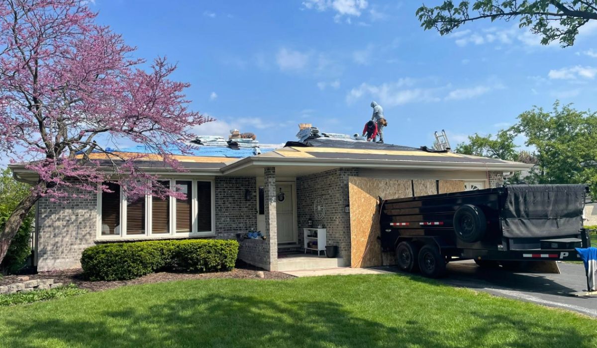Licensed roofing contractor Lockport IL crew working on a home with full cleanup setup and proper safety protocols.