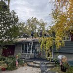 DNS Exterior roofing crew installing new roofing underlayment during a residential roof replacement in Lockport, IL.