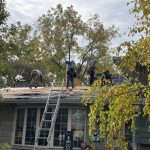 Roofing crew installing new underlayment during a residential roof replacement by DNS Exterior in Lockport, IL.