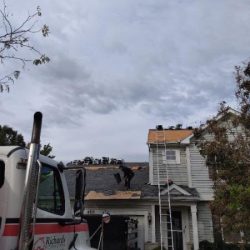 Roofing company in Romeoville, IL replacing shingles and installing a new roof on a residential home.