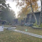 Residential roof replacement in progress by DNS Exterior in Lockport, IL, showing crew setup with ladders and equipment.