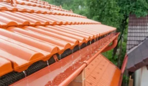 Rainwater flowing from roof into gutters showing drainage behavior when you inspect your home exterior